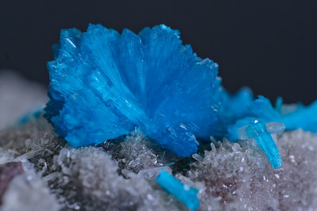 Beautiful radiating blue mineral crystals over a bed of sugary white mineral crystals, demonstrating God's creativity