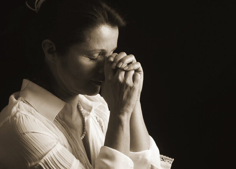 Woman praying and sincerely seeking God