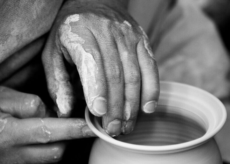 A potter's hands forming a pot out of wet clay, representing God forming Israel into his own nation