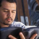 Young man reading the Bible and applying sound Bible interpretation methods to avoid Bible interpretation errors.