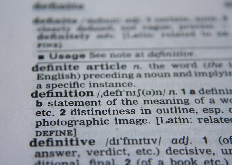 Open dictionary showing definitions of words, as discussed in the article, misleading definitions exist for some important Christian words