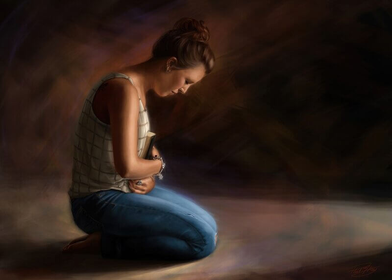 Woman kneeling in prayer and covering her heart in a symbolic gesture to obey the command to "guard your heart"